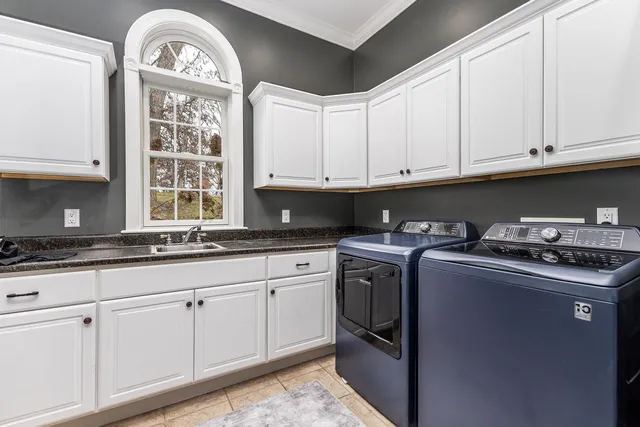 a kitchen with granite countertop a sink a stove and cabinets