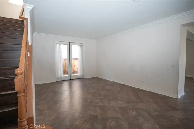 an empty room with windows and a fireplace