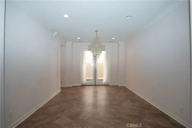 an empty room with windows and a fireplace