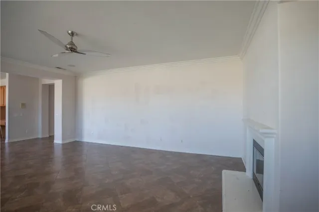 an empty room with wooden floor closet and windows
