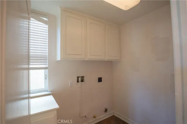 a view of a livingroom with wooden floor and a window