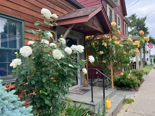 a vase of flowers sitting on a floor