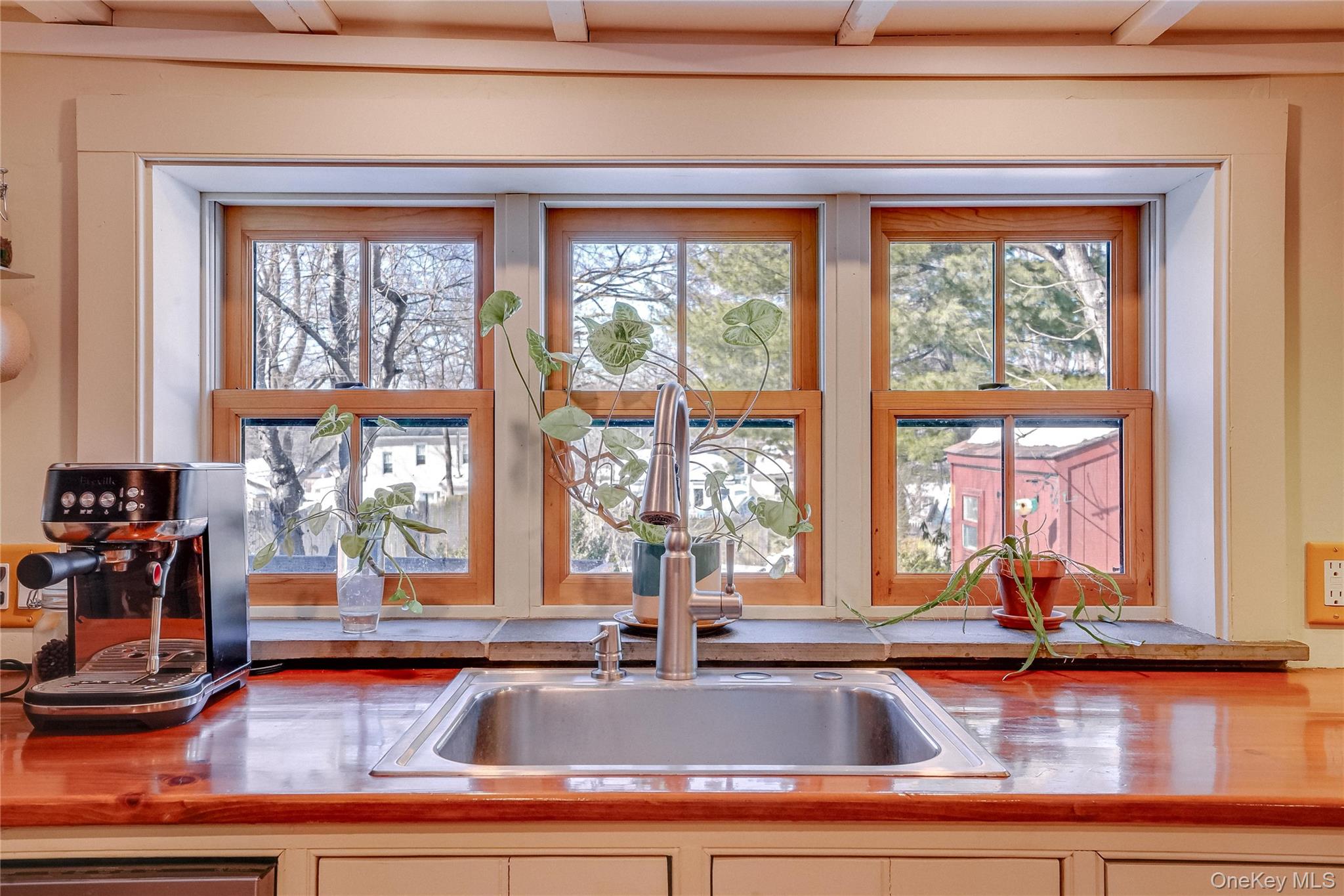 46 Union Street Montgomery, NY 12549 - Photo 28 of 38 a kitchen sink with granite countertop a coffee maker next to a window