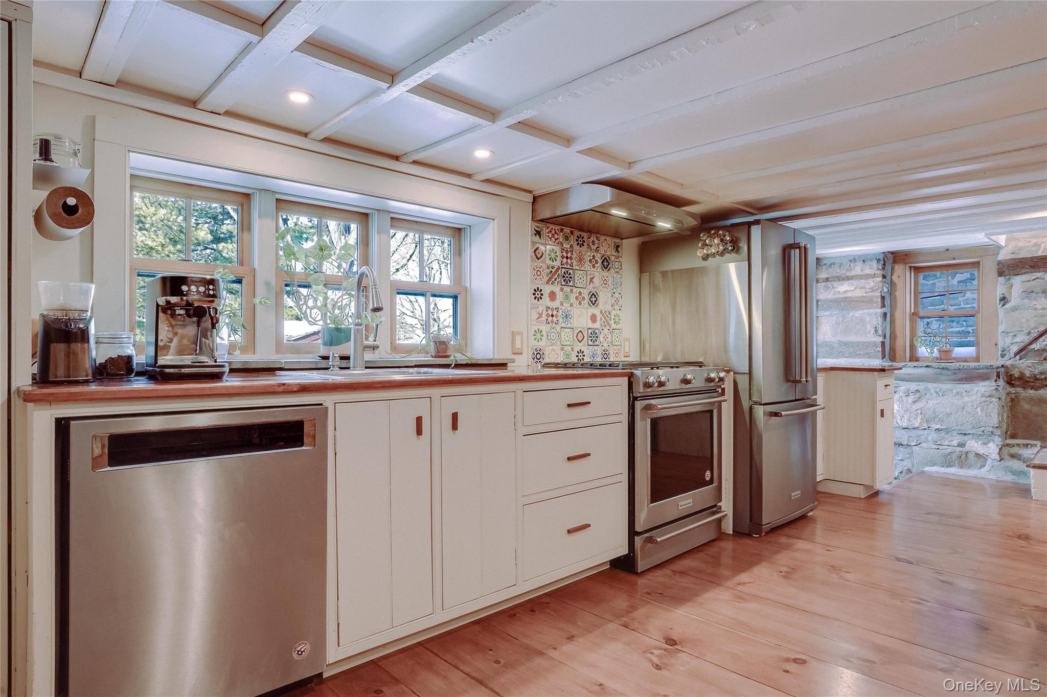 46 Union Street Montgomery, NY 12549 - Photo 29 of 38 a kitchen with stainless steel appliances kitchen island granite countertop a stove a sink and a refrigerator