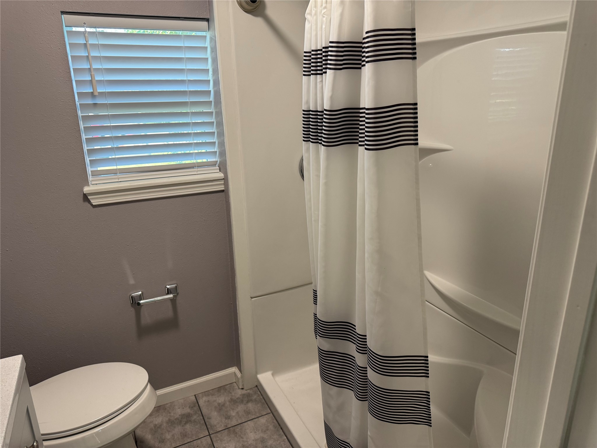 726 4th Street San Leon, TX 77539 - Photo 13 of 14 a bathroom with a toilet and a shower