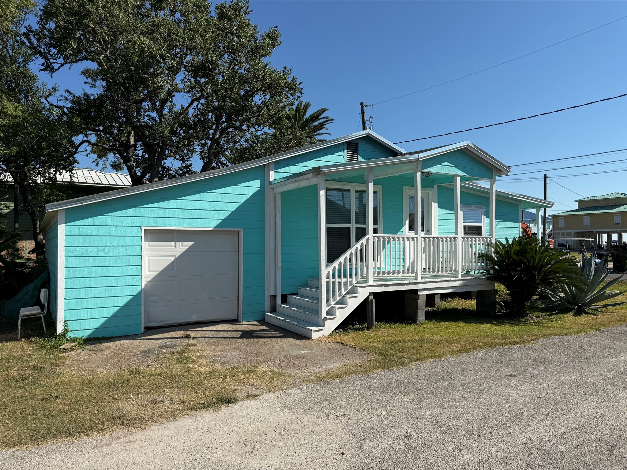 726 4th Street San Leon, TX 77539 - Photo 2 of 14 a front view of a house with a yard and garage
