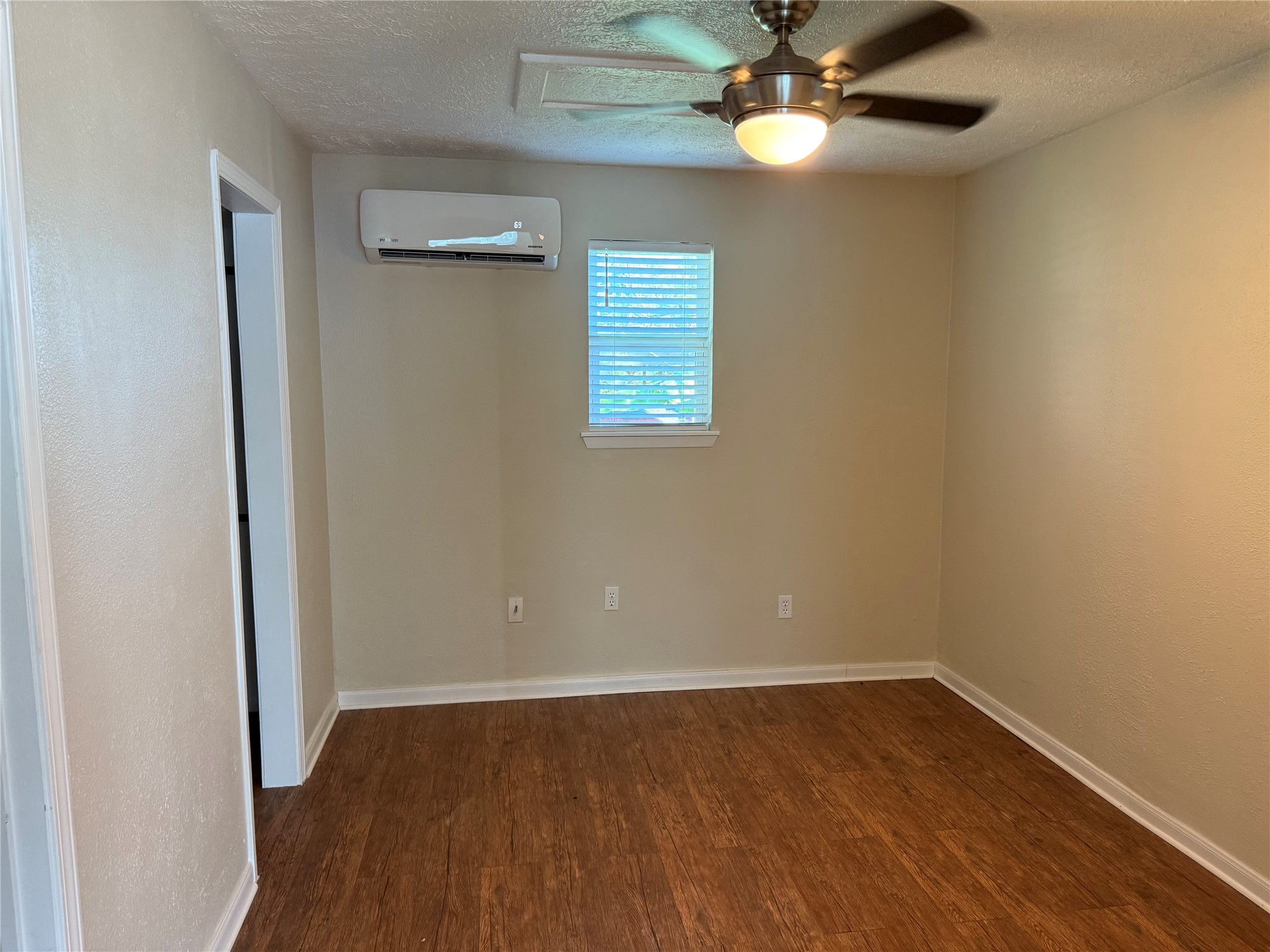 726 4th Street San Leon, TX 77539 - Photo 6 of 14 a view of an empty room with wooden floor and a window