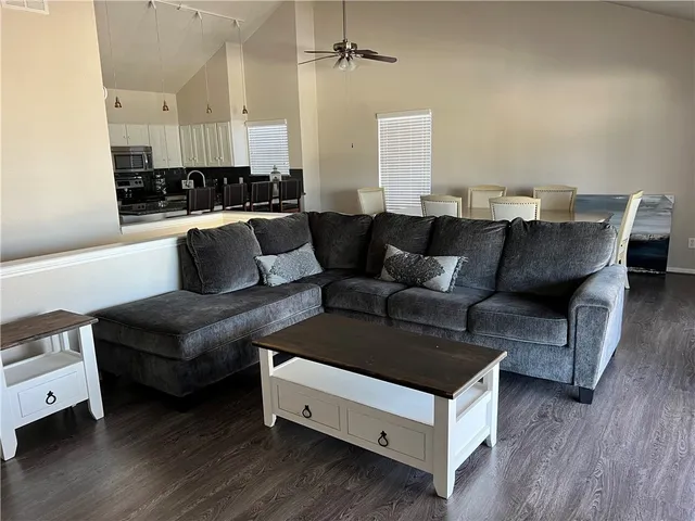 a living room with furniture and wooden floor