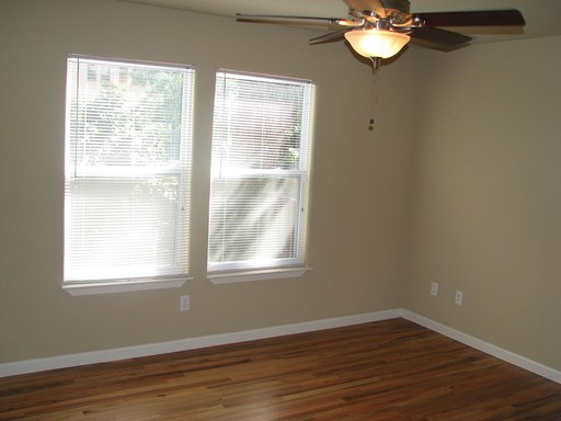 907 West 30th Street, Unit B Austin, TX 78705 - Photo 15 of 20 a view of an empty room with wooden floor and a window