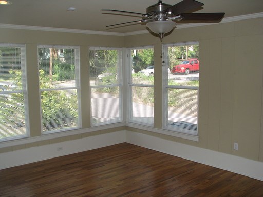 907 West 30th Street, Unit B Austin, TX 78705 - Photo 19 of 20 a view of an empty room with wooden floor and windows