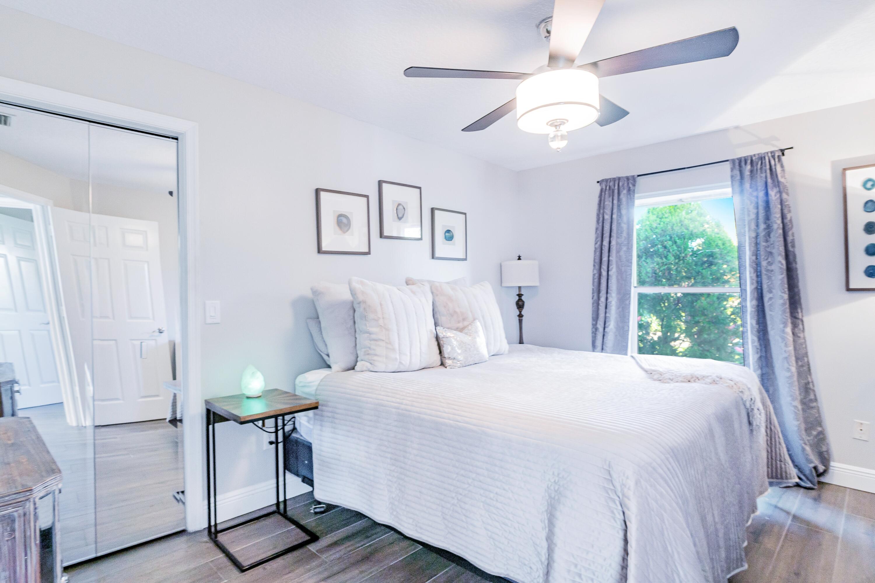 1350 Longlea Terrace Wellington, FL 33414 - Photo 31 of 61 a bedroom with a bed and a chandelier