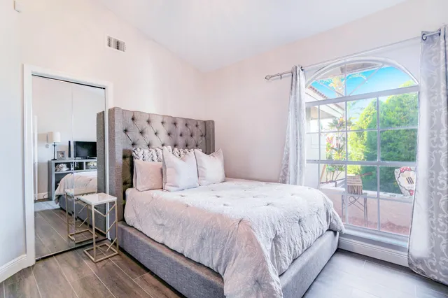 a bedroom with furniture and a flat screen tv