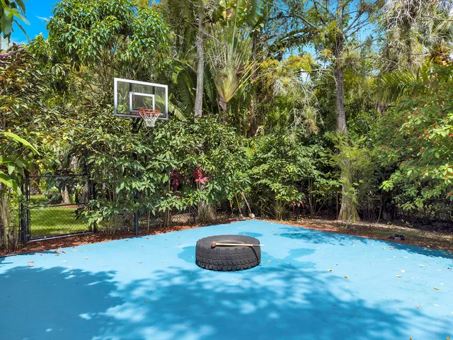 a living room with furniture gym equipment and a large window