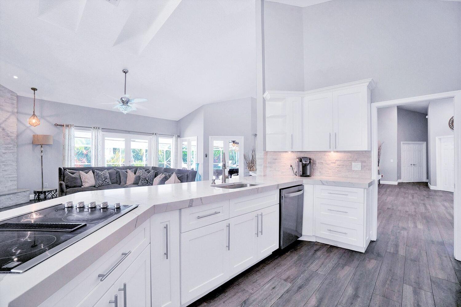 1350 Longlea Terrace Wellington, FL 33414 - Photo 5 of 61 a kitchen with a sink stove cabinets and wooden floor