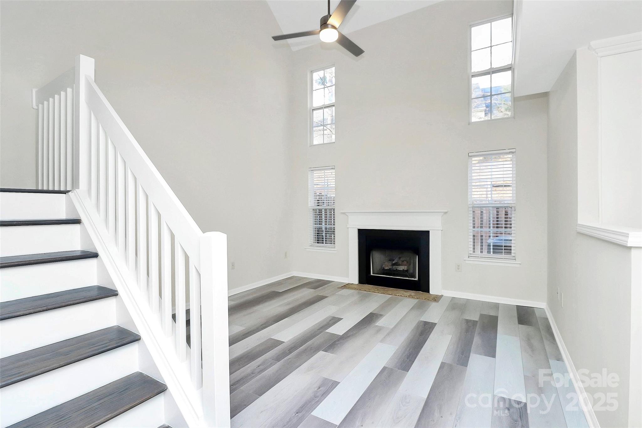 441 Robin Reed Court Pineville, NC 28134 - Photo 14 of 33 a view of a livingroom with wooden floor a fireplace and a window