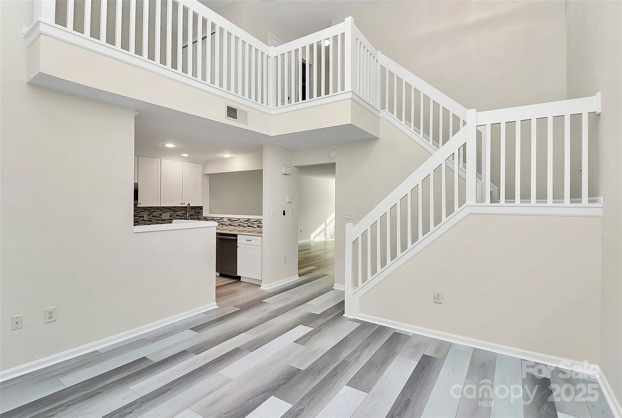 441 Robin Reed Court Pineville, NC 28134 - Photo 17 of 33 a view of staircase with white walls and white floor
