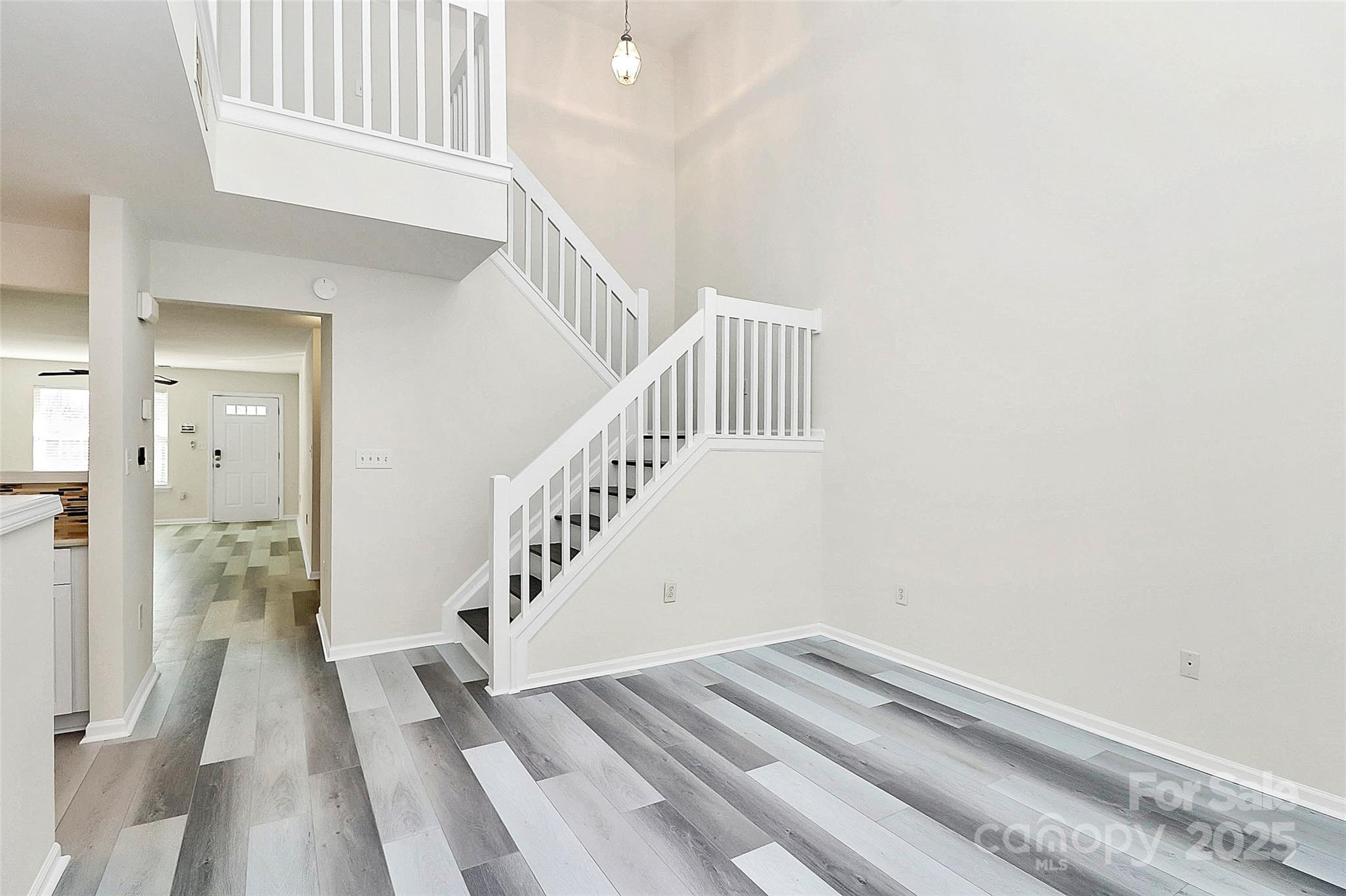 441 Robin Reed Court Pineville, NC 28134 - Photo 18 of 33 a view of staircase with white walls and a window