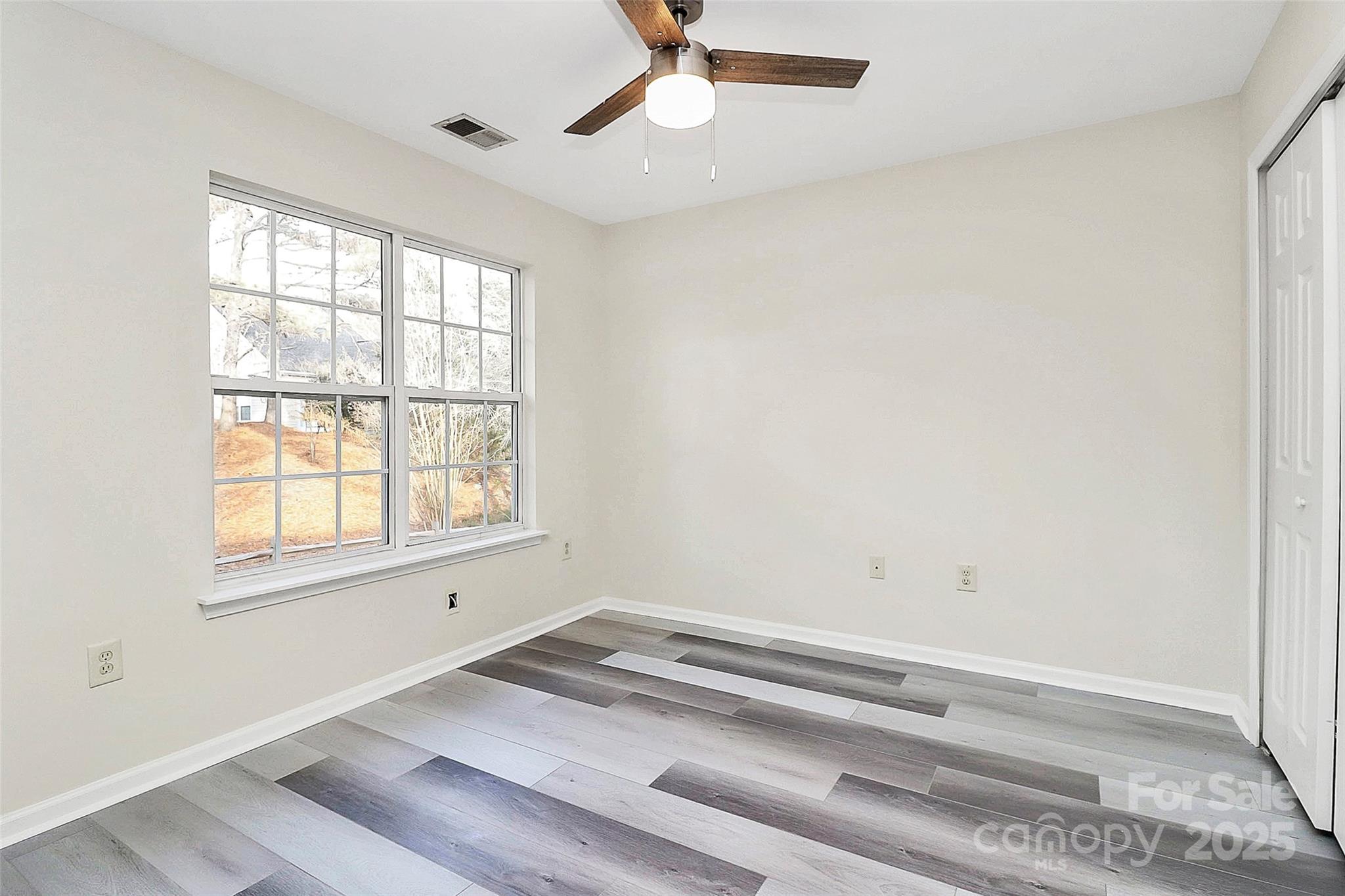441 Robin Reed Court Pineville, NC 28134 - Photo 19 of 33 an empty room with a window and ceiling fan