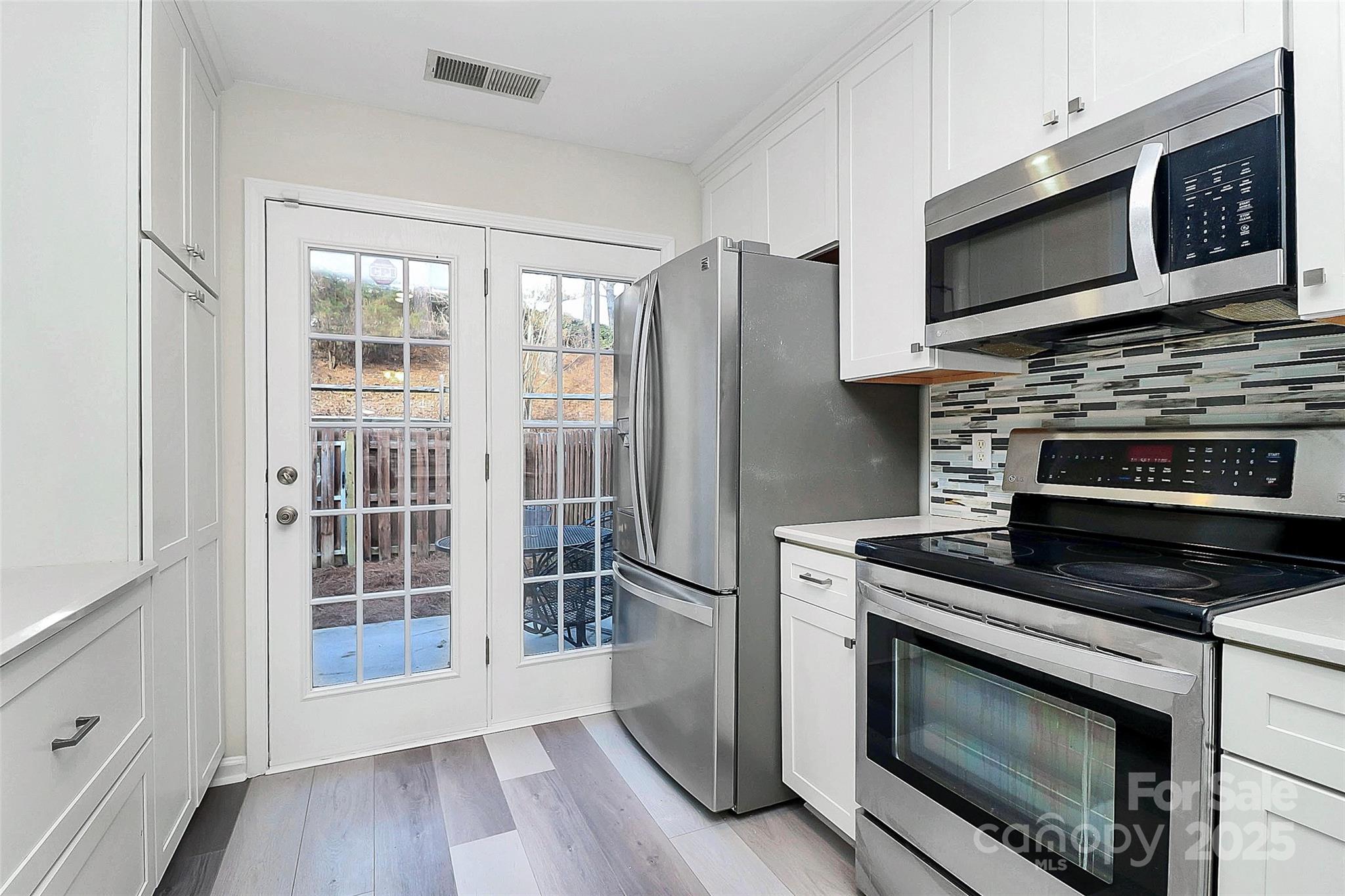 441 Robin Reed Court Pineville, NC 28134 - Photo 6 of 33 a kitchen with granite countertop a stove and a microwave