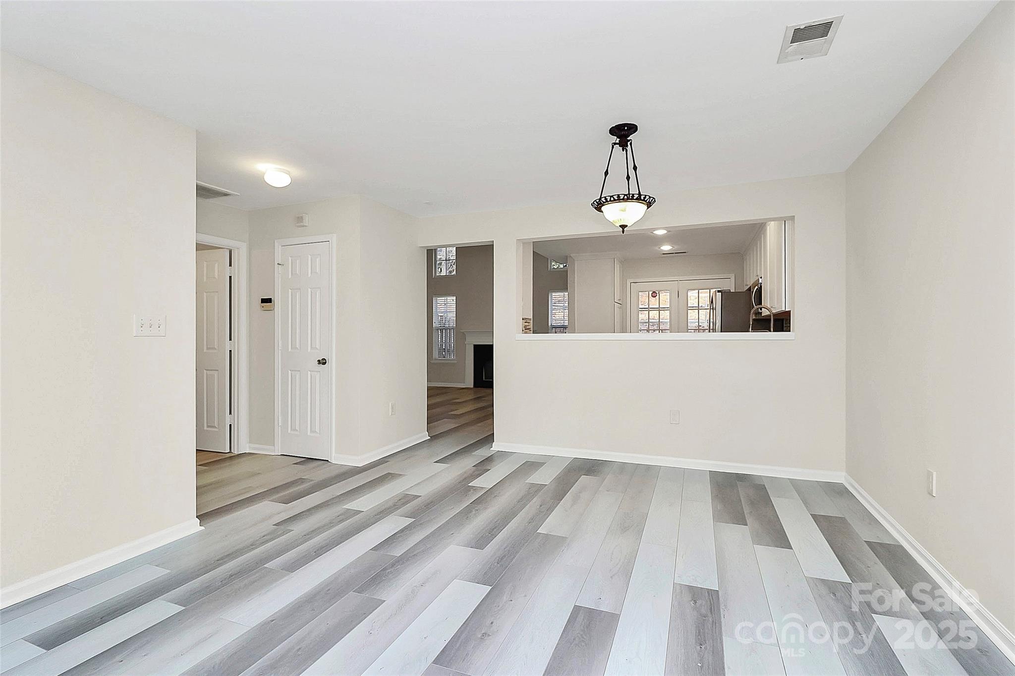 441 Robin Reed Court Pineville, NC 28134 - Photo 8 of 33 wooden floor in an empty room with a window