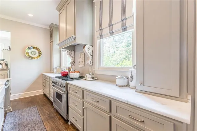 a bedroom with furniture large window and wooden floor