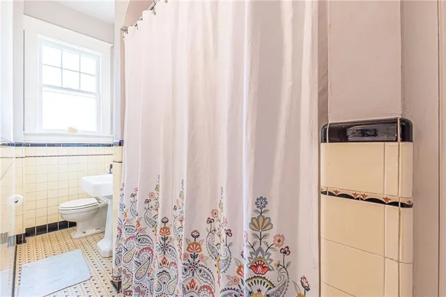 a living room with furniture a rug and a book shelf