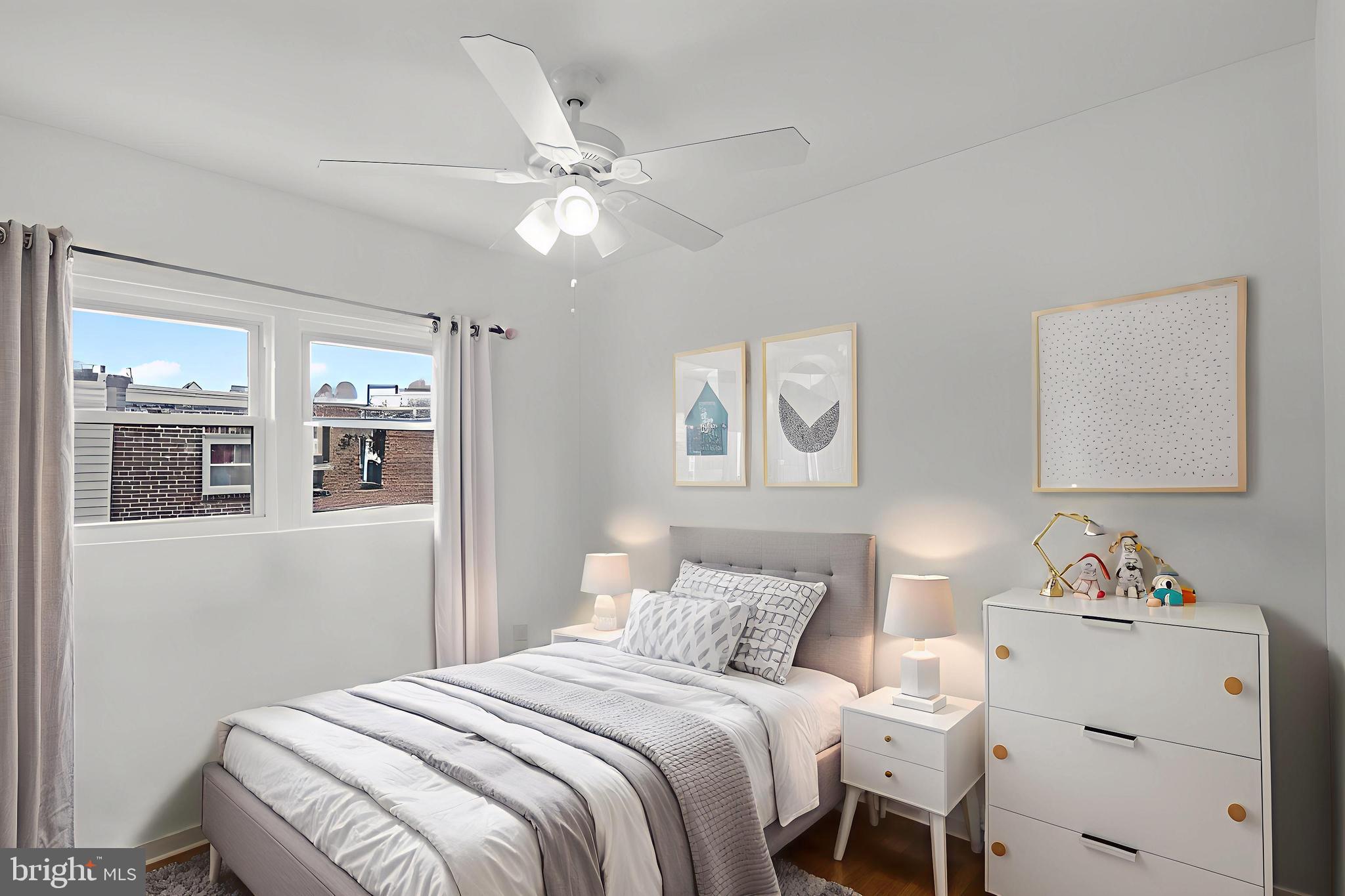 7734 Temple Road Philadelphia, PA 19150 - Photo 16 of 33 a bedroom with a bed and a chandelier