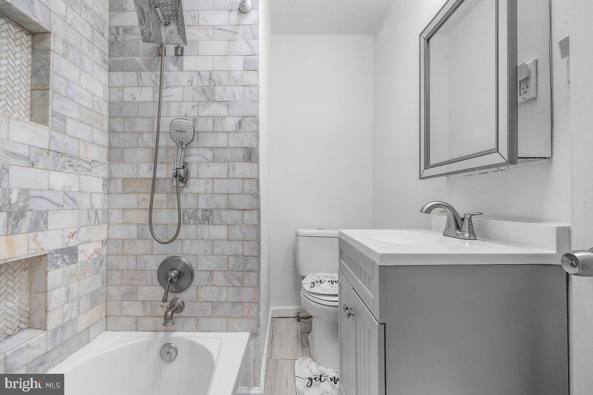 7734 Temple Road Philadelphia, PA 19150 - Photo 17 of 33 a bathroom with a sink toilet and shower