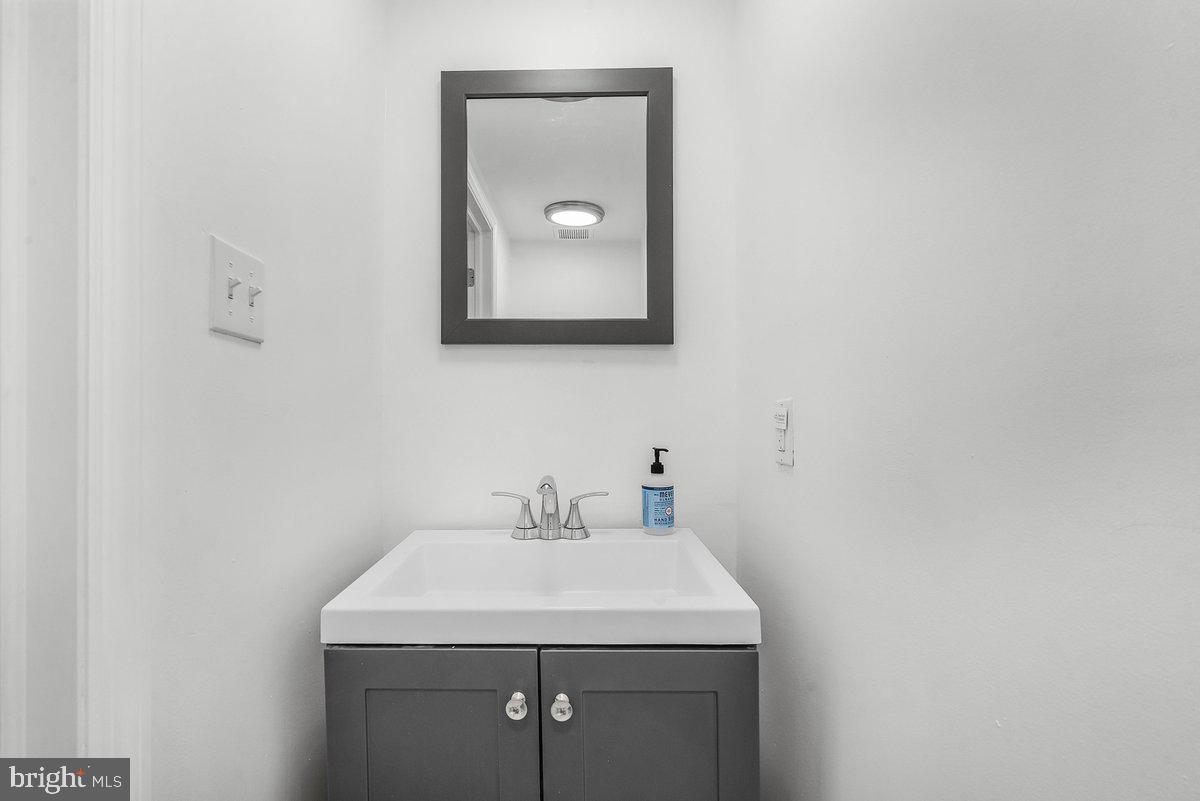 7734 Temple Road Philadelphia, PA 19150 - Photo 20 of 33 a bathroom with a toilet sink and mirror