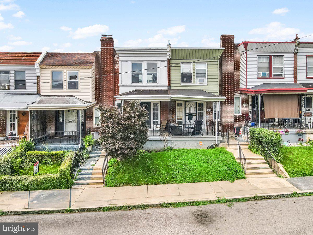 7734 Temple Road Philadelphia, PA 19150 - Photo 25 of 33 a front view of a residential apartment building with a yard