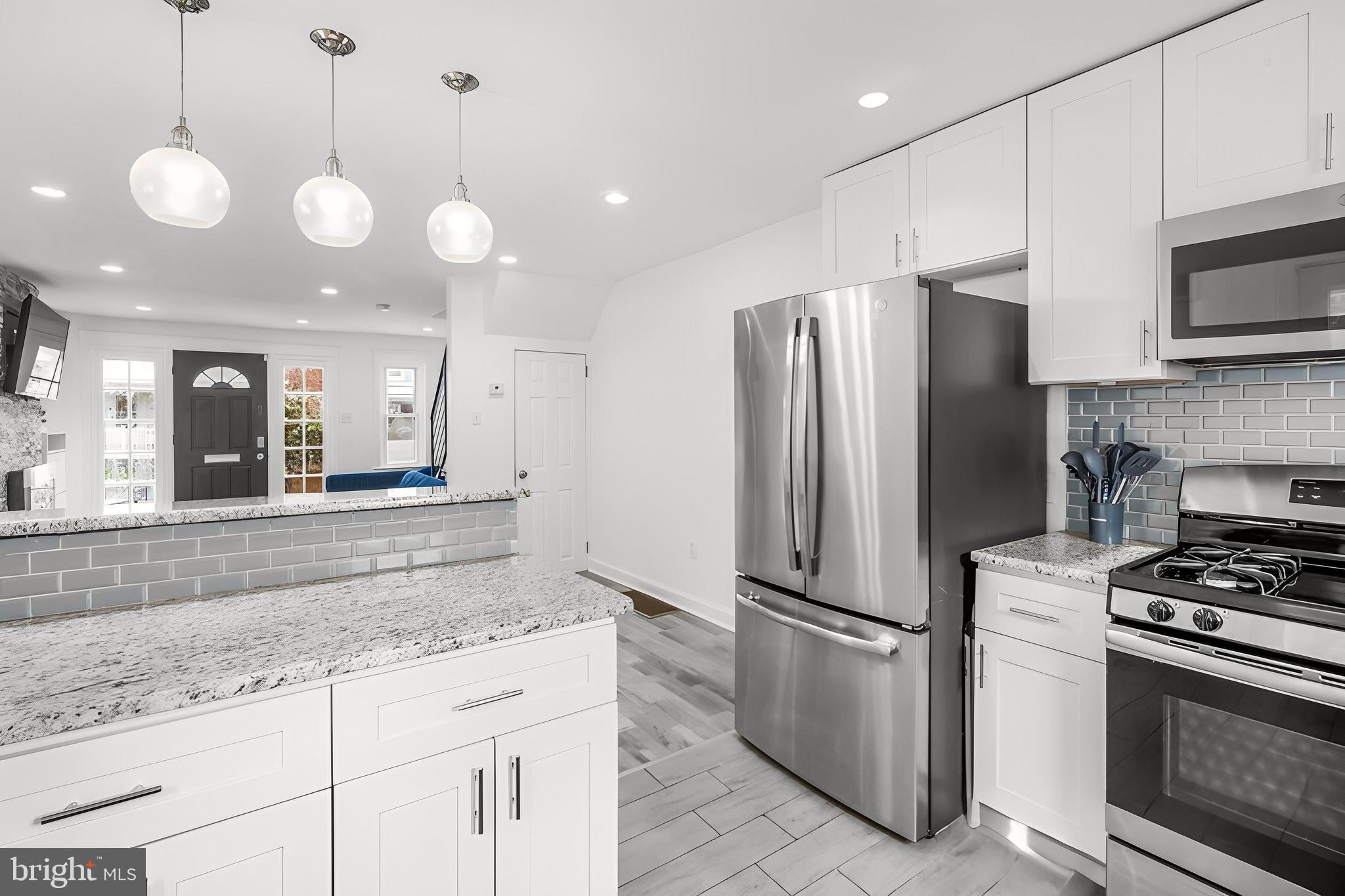 7734 Temple Road Philadelphia, PA 19150 - Photo 8 of 33 a kitchen with stainless steel appliances granite countertop a stove a refrigerator and a sink
