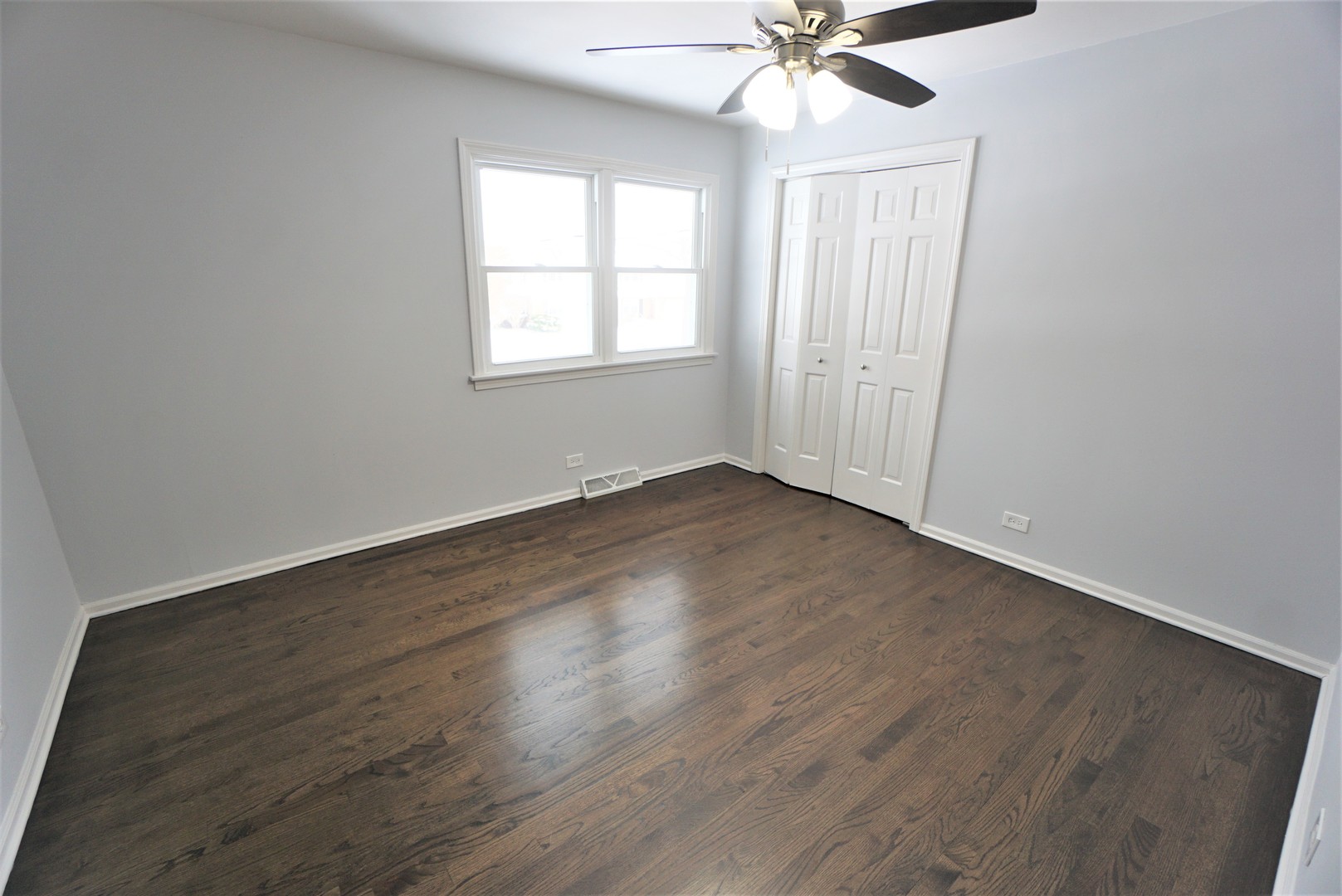2842 Scott Crescent Flossmoor, IL 60422 - Photo 26 of 43 an empty room with wooden floor chandelier fan and windows