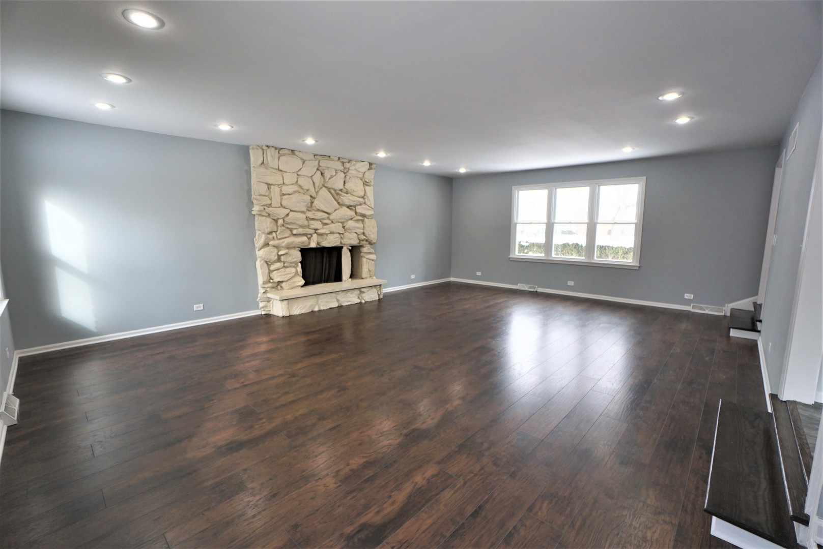 2842 Scott Crescent Flossmoor, IL 60422 - Photo 4 of 43 an empty room with wooden floor fireplace and windows