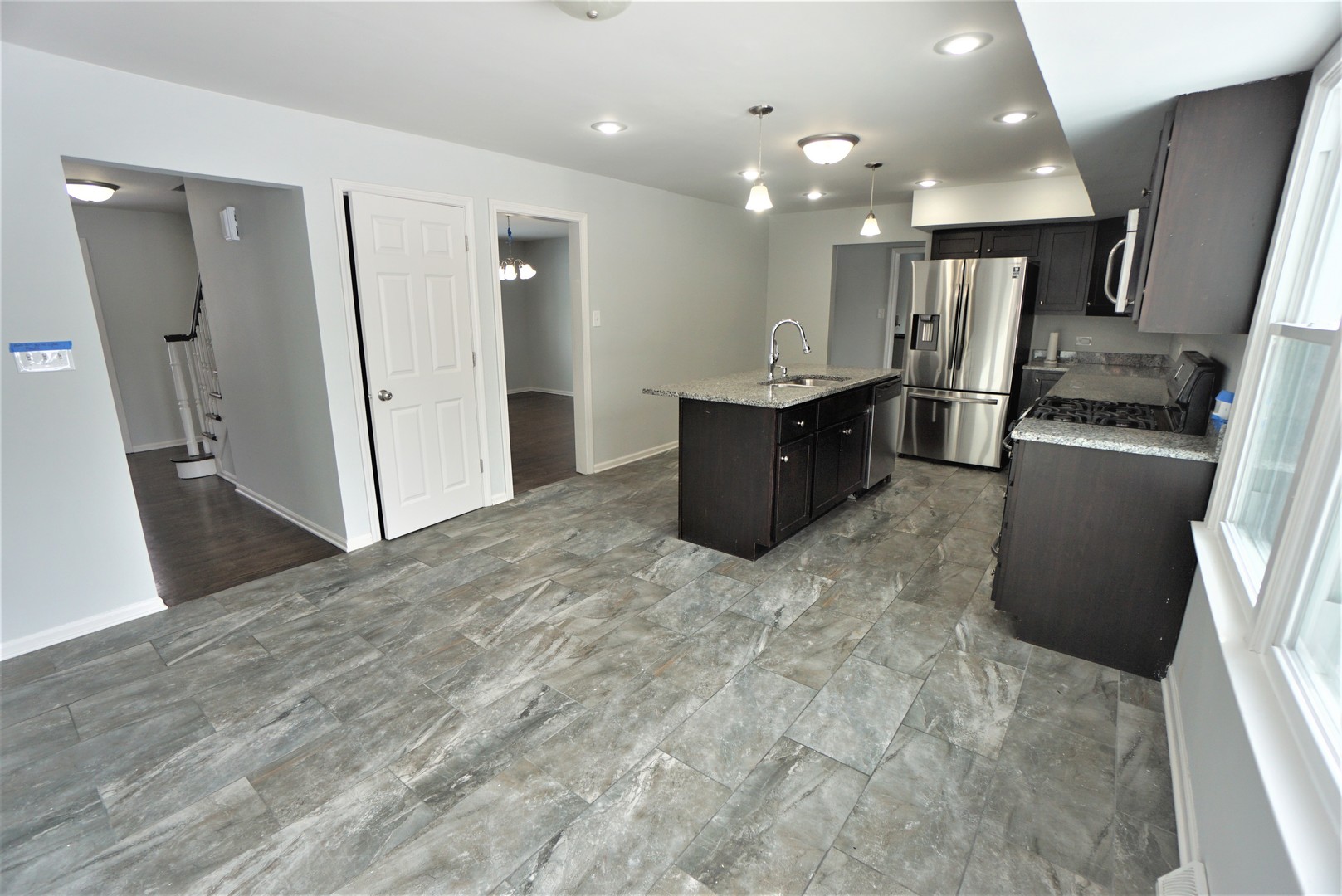2842 Scott Crescent Flossmoor, IL 60422 - Photo 8 of 43 a large kitchen with stainless steel appliances kitchen island granite countertop a large counter top and wooden floors