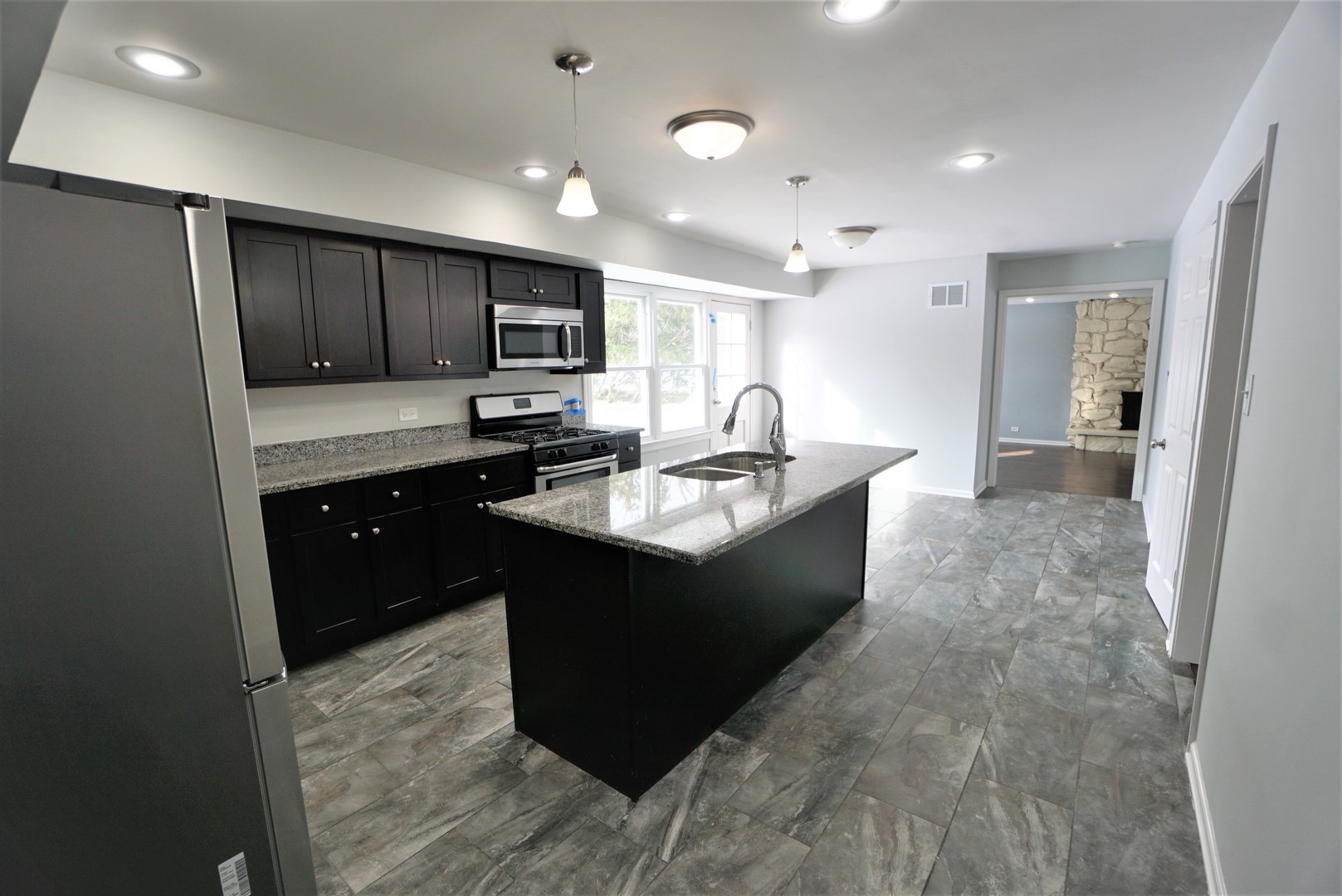 2842 Scott Crescent Flossmoor, IL 60422 - Photo 9 of 43 a kitchen with kitchen island sink refrigerator and cabinets