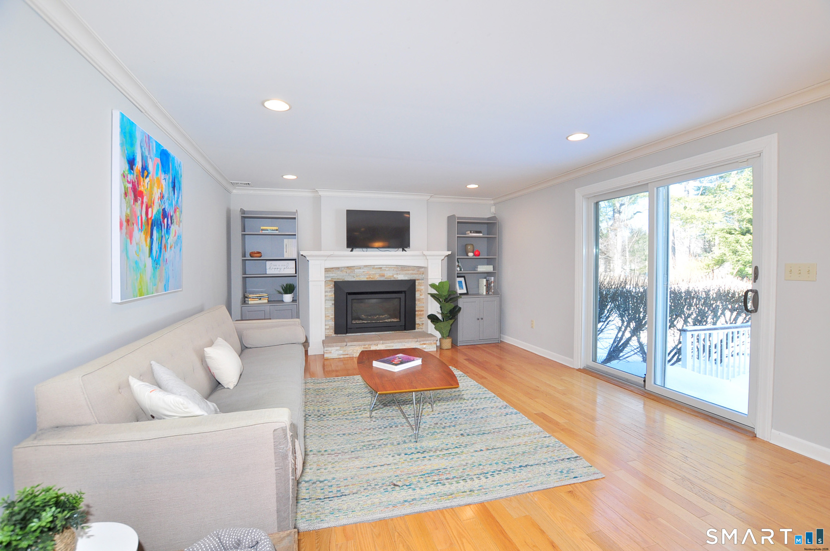90 Seminary Road Simsbury, CT 06070 - Photo 11 of 34 a living room with furniture a flat screen tv and a fireplace