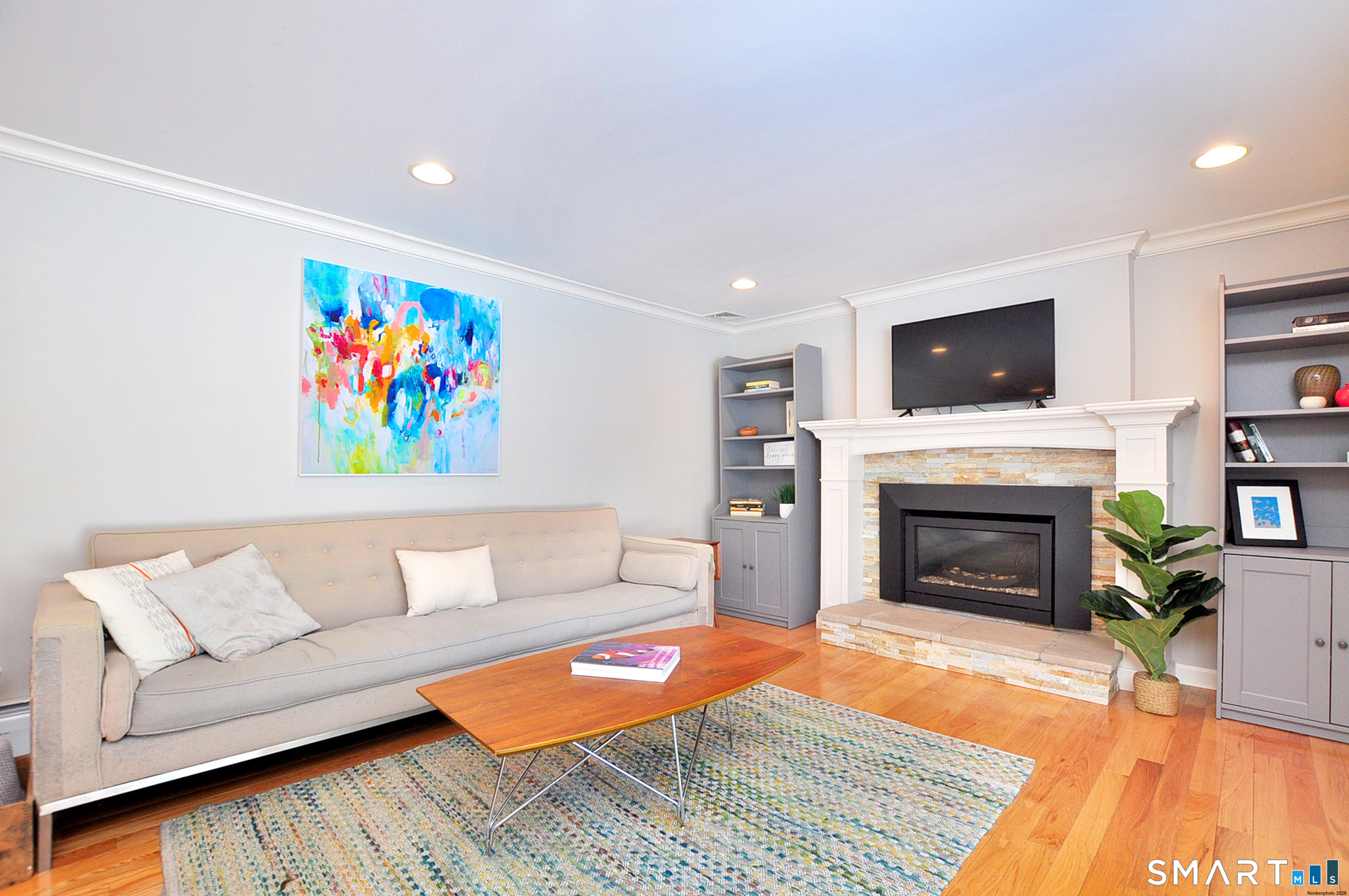 90 Seminary Road Simsbury, CT 06070 - Photo 12 of 34 a living room with furniture a flat screen tv and a fireplace