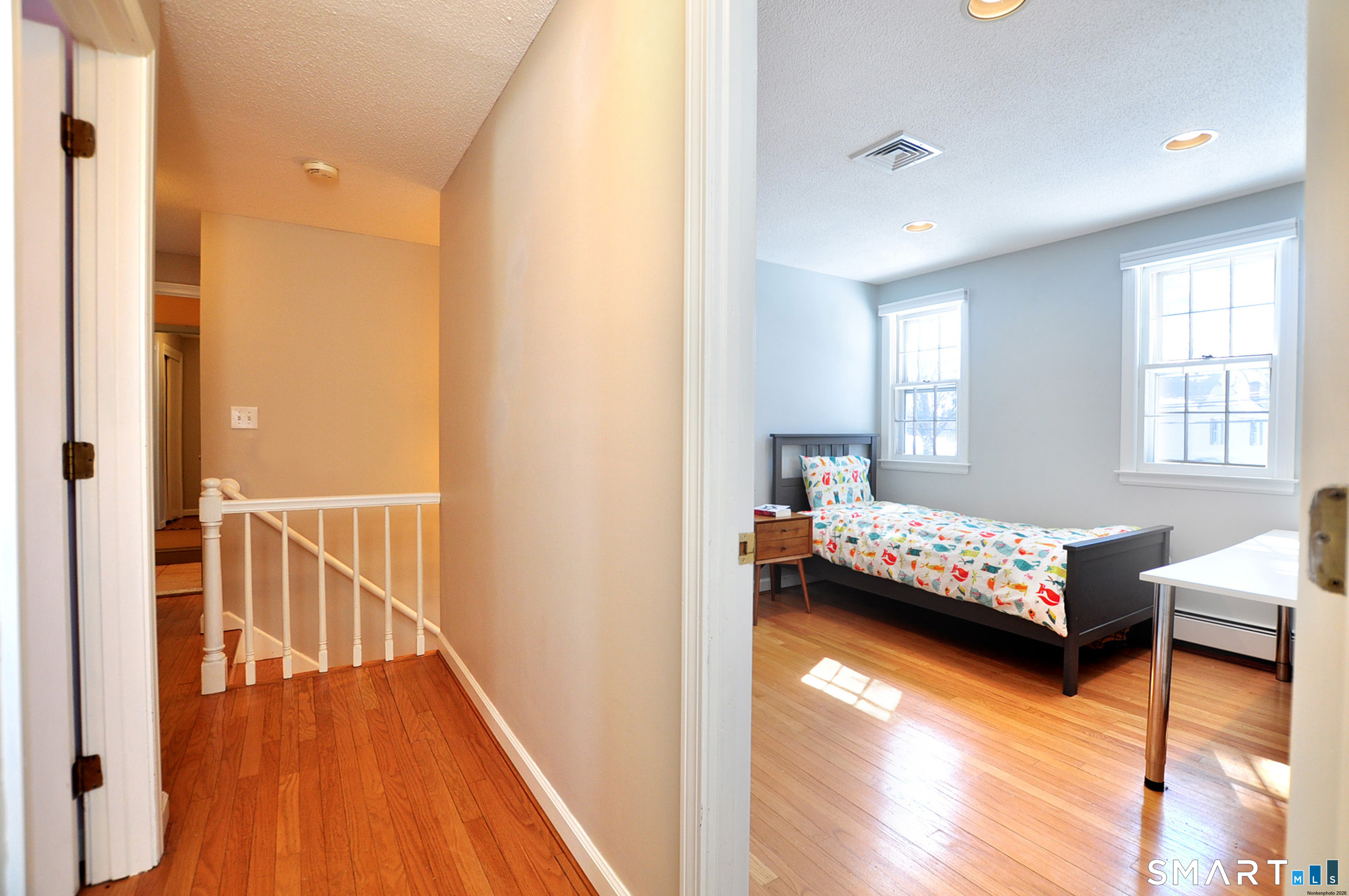 90 Seminary Road Simsbury, CT 06070 - Photo 22 of 34 a bedroom with a bed and wooden floor