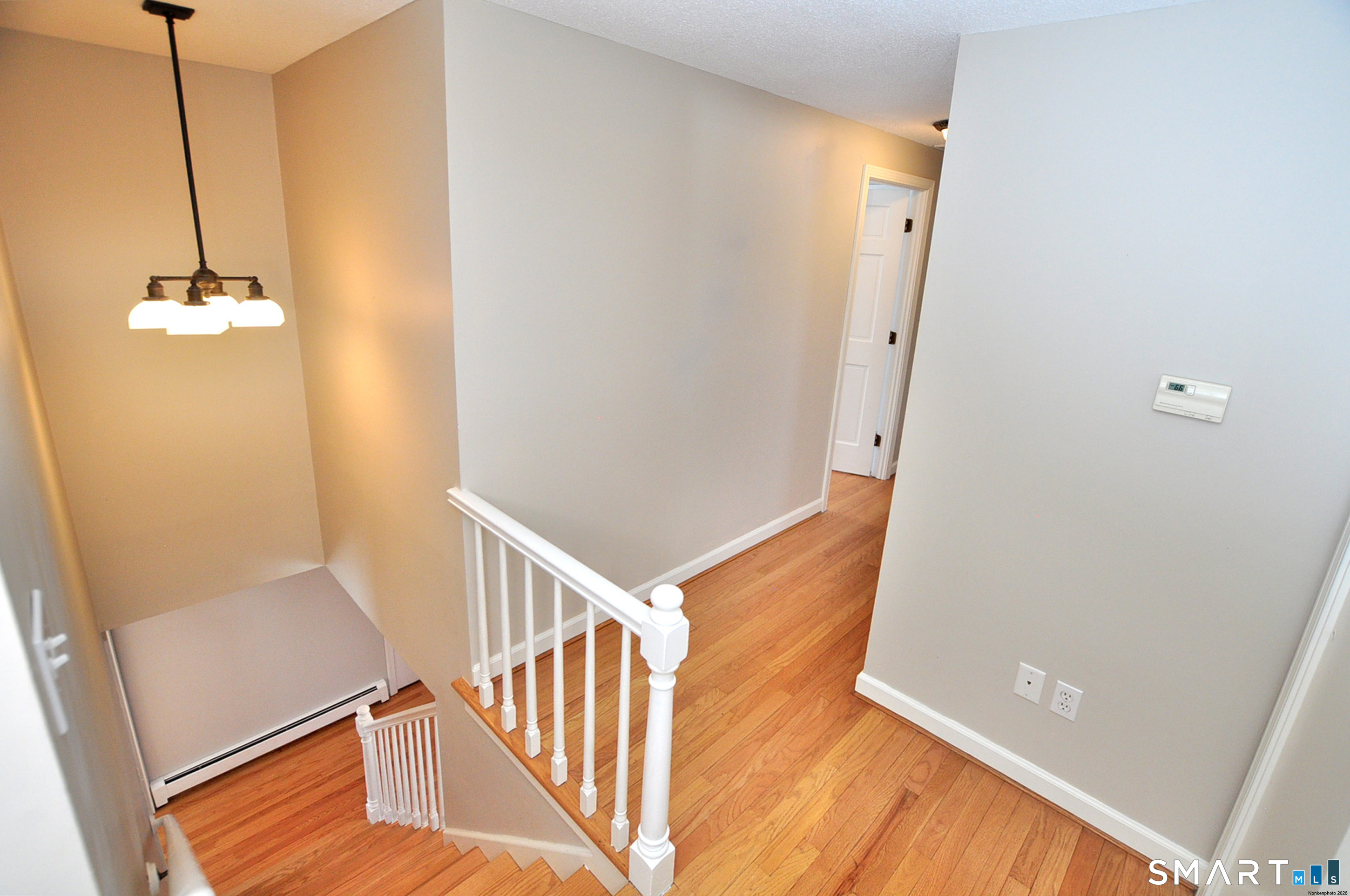 90 Seminary Road Simsbury, CT 06070 - Photo 3 of 34 a view of a hallway with wooden floor and staircase