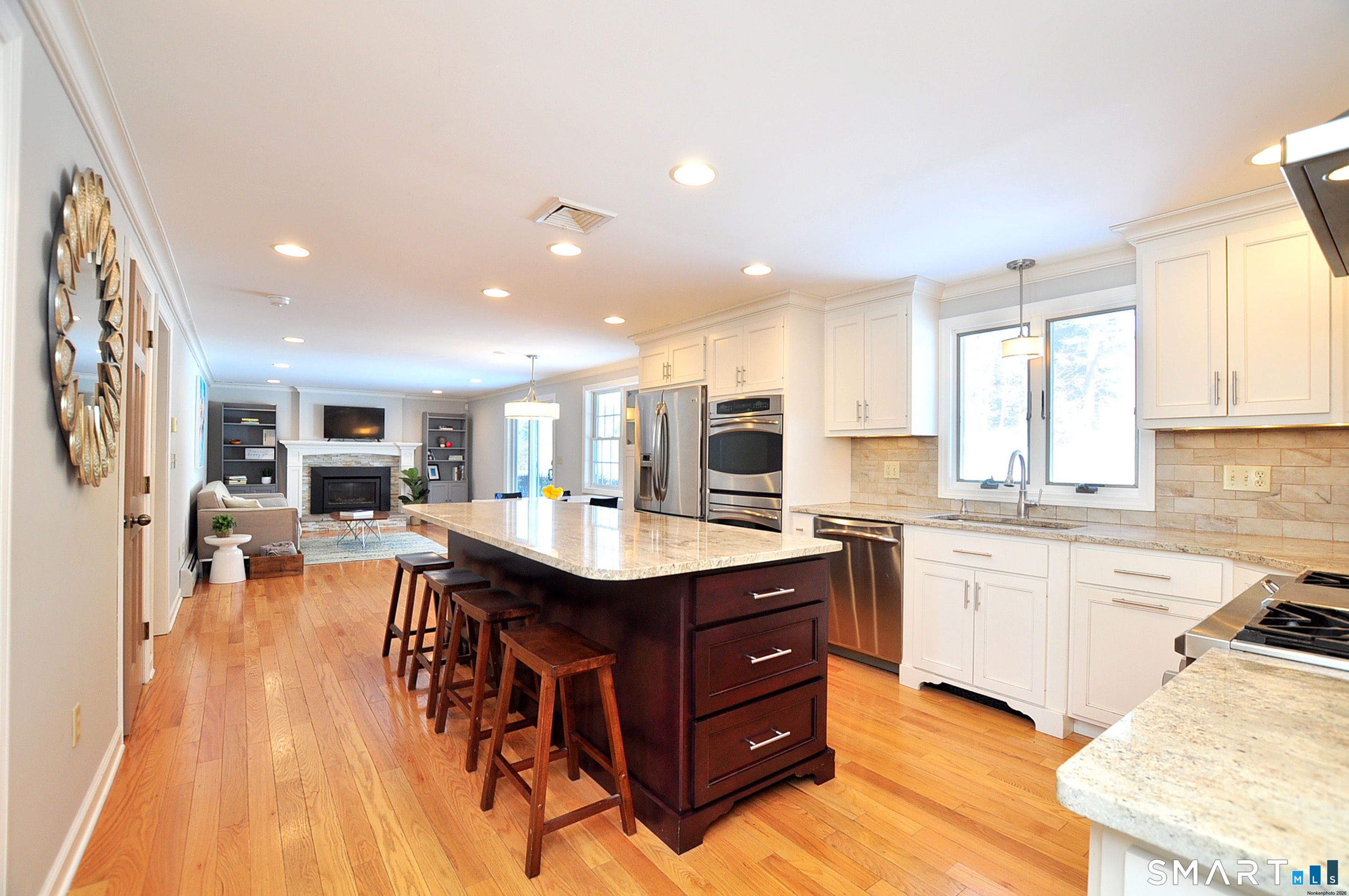 90 Seminary Road Simsbury, CT 06070 - Photo 8 of 34 a kitchen with a sink and wooden cabinets