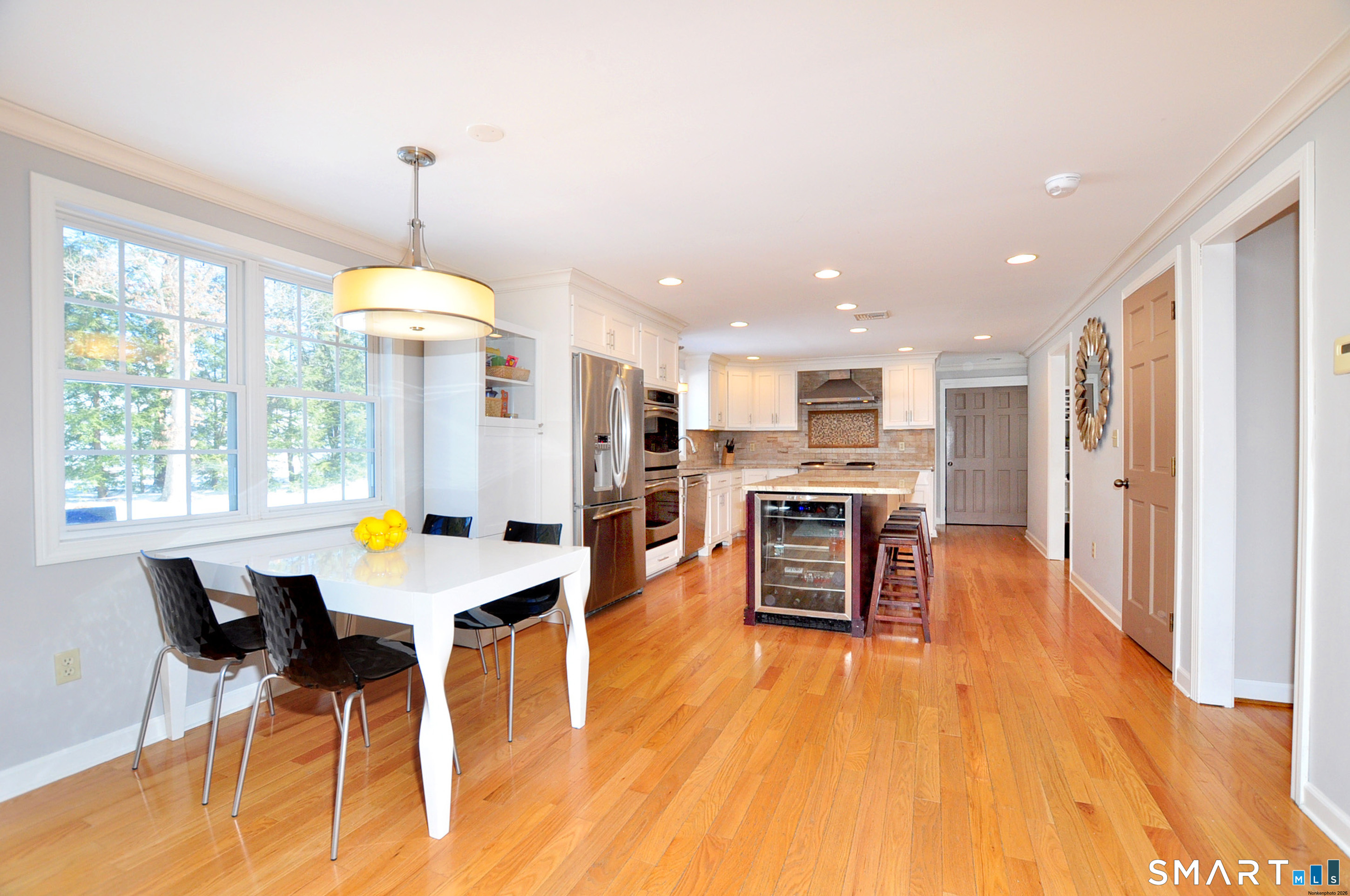 90 Seminary Road Simsbury, CT 06070 - Photo 9 of 34 a open kitchen view with stainless steel appliances refrigerator stove dining table and chairs