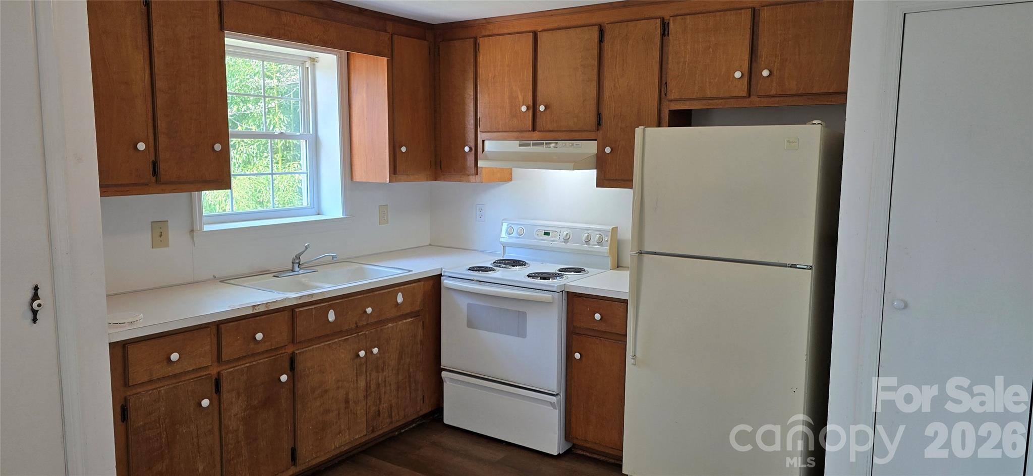 4169 Grace Chapel Road Granite Falls, NC 28630 - Photo 2 of 31 a kitchen with a refrigerator sink stove and cabinets