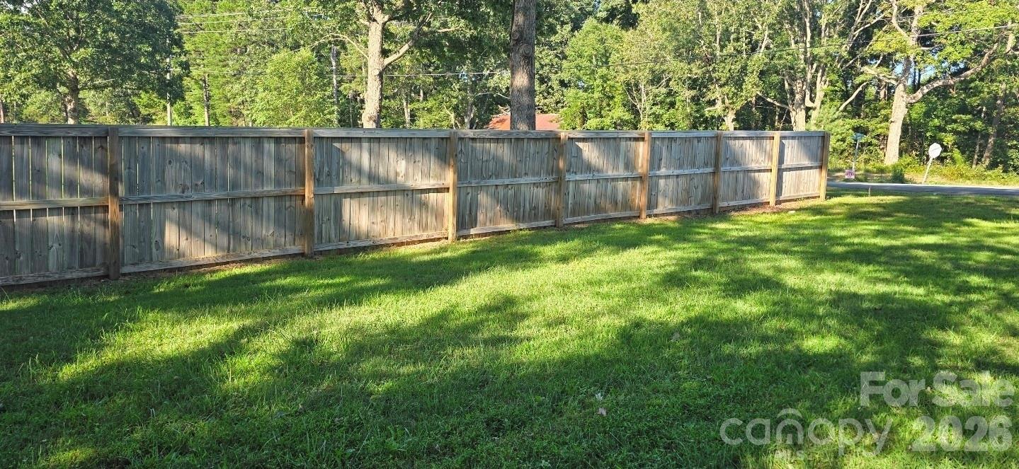 4169 Grace Chapel Road Granite Falls, NC 28630 - Photo 24 of 31 a view of a backyard with a fence and trees