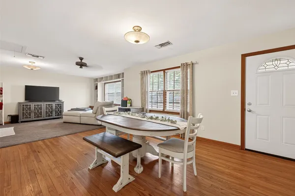 a dining room with furniture and wooden floor