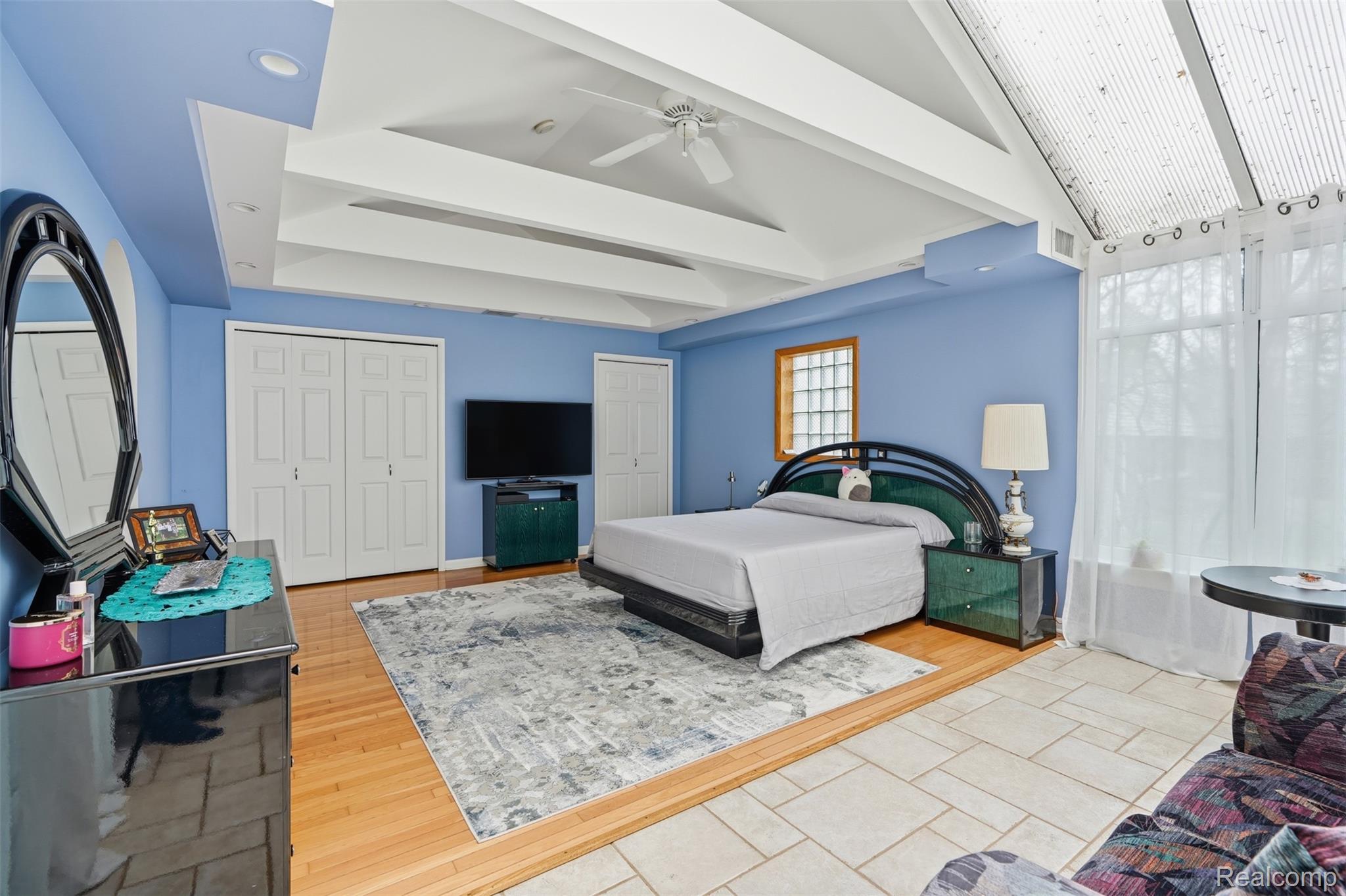 2210 Lancaster Road Bloomfield Hills, MI 48302 - Photo 18 of 35 Bedroom with two closets, light wood finished floors, a ceiling fan, and beamed ceiling