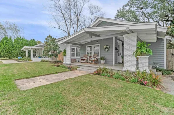 a front view of a house with a yard table and chairs