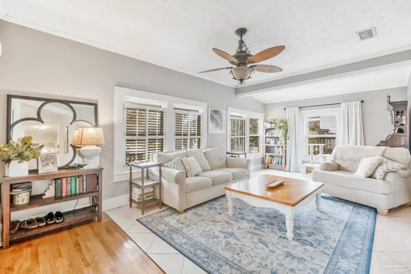 a kitchen with stainless steel appliances a stove top oven a sink a refrigerator and white cabinets