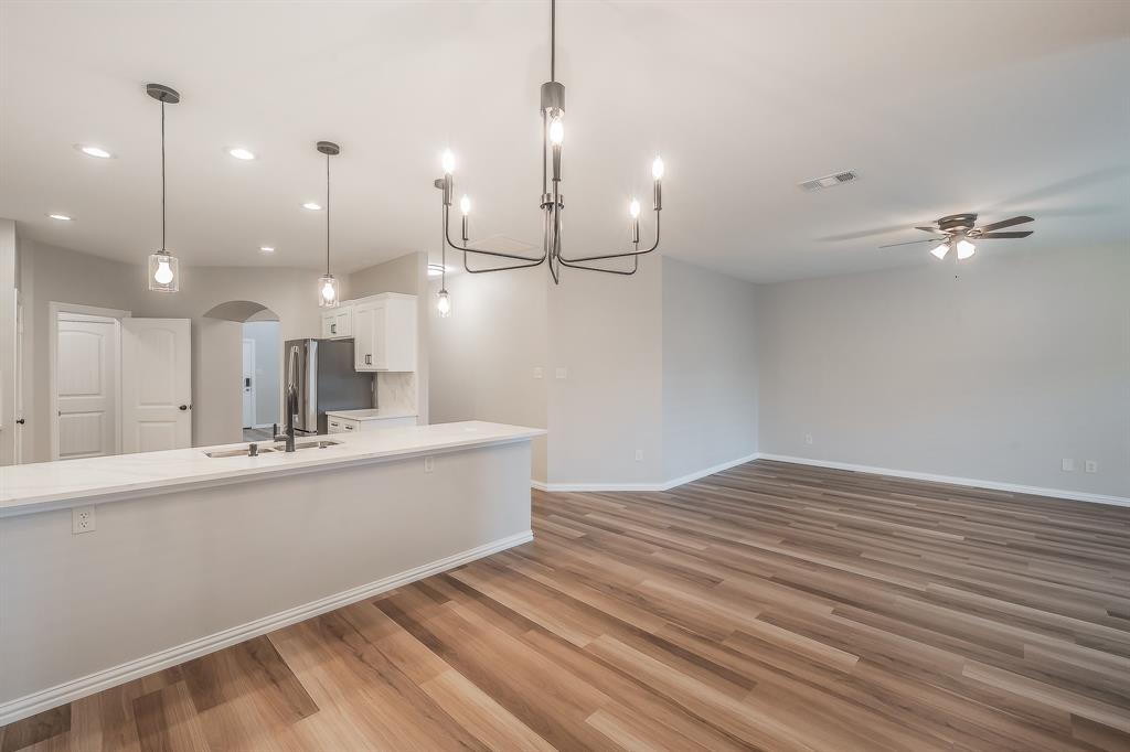 412 Hideaway Road McKinney, TX 75072 - Photo 13 of 40 a view of a kitchen with a sink and wooden floor