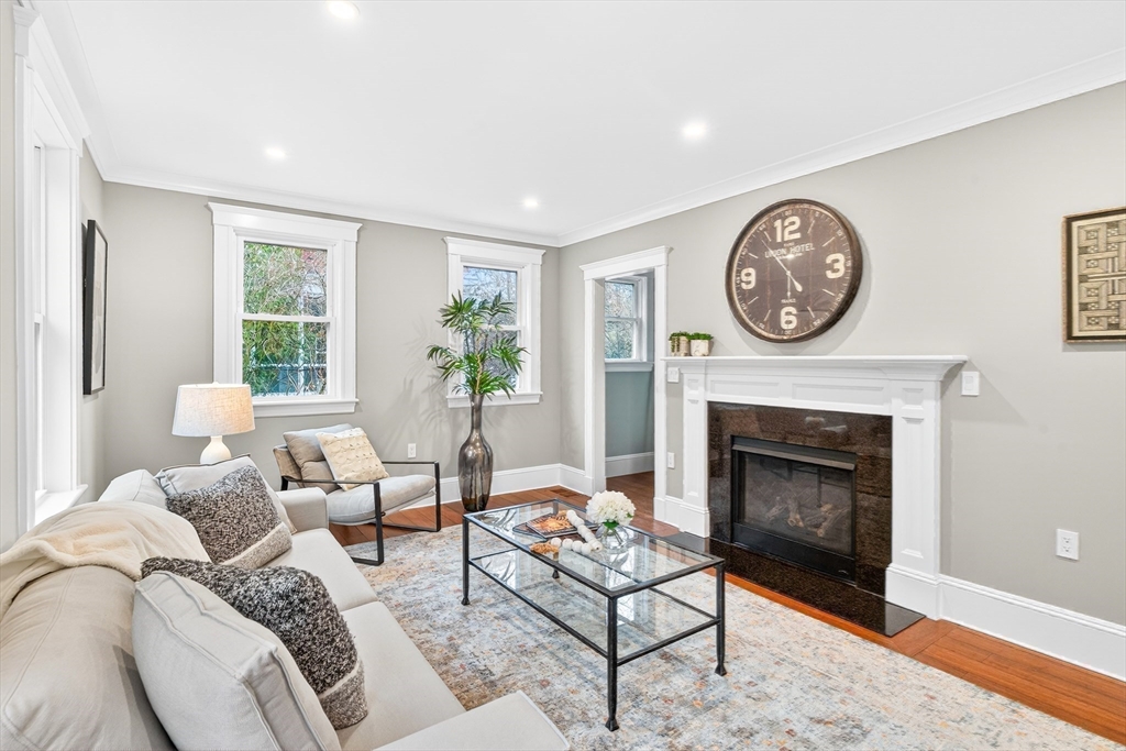 524 Ward Street Newton, MA 02459 - Photo 13 of 42 a living room with furniture a clock and a fireplace