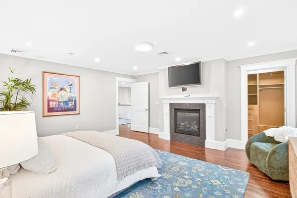 a bedroom with a bed and a fireplace